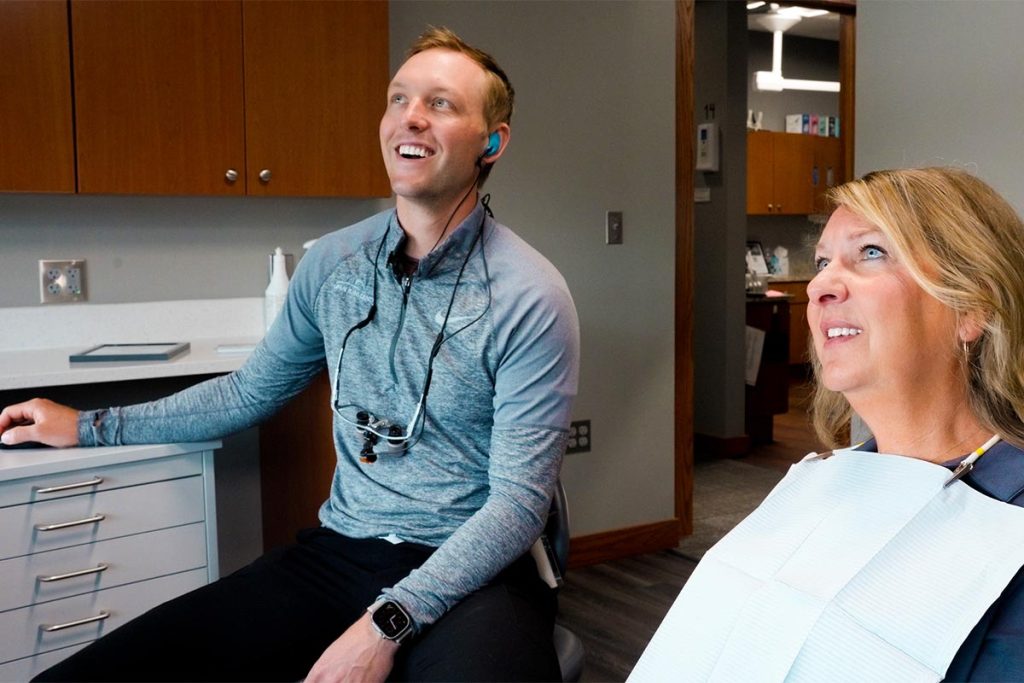 Dr. Brock Nelsen talks with a patient in the Great Plains Dental office in Sioux Falls, SD