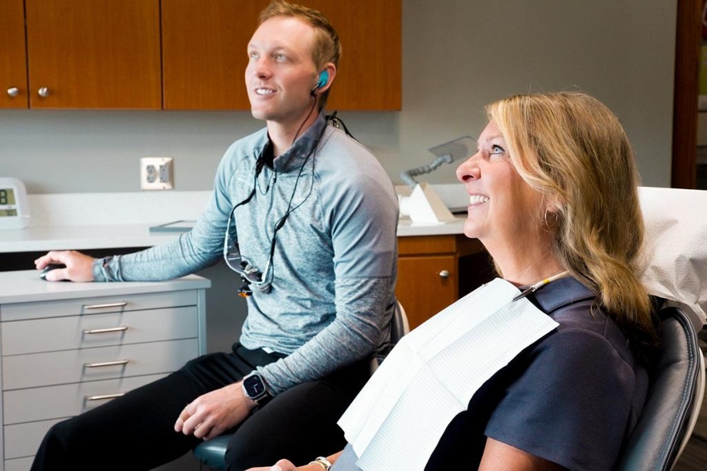 Dr. Brock Nelsen talks with a patient in the Great Plains Dental office in Sioux Falls, SD