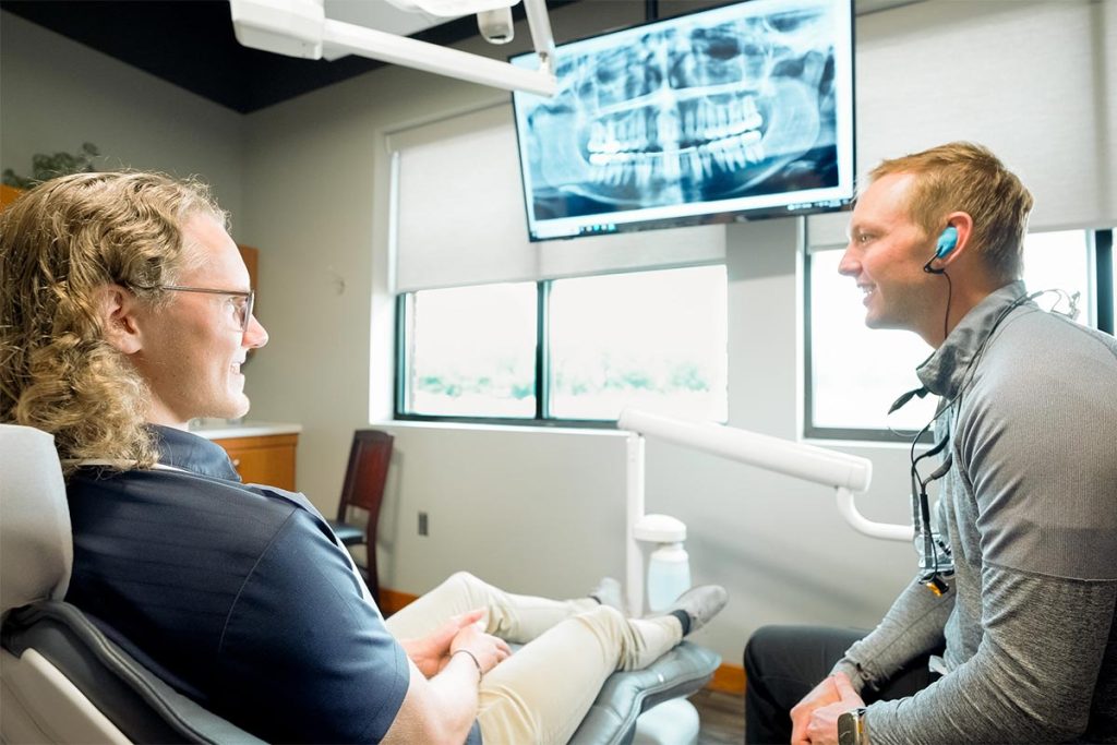 Dr. Brock Nelsen talks with a patient in the Great Plains Dental office in Sioux Falls, SD