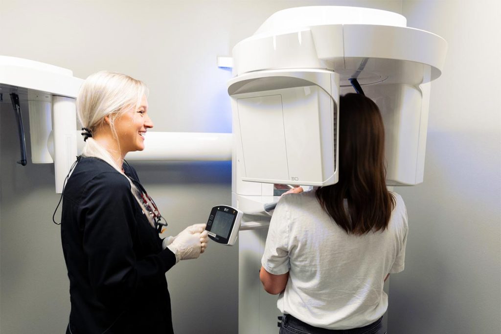 An employee assists a patient during the x-ray process at Great Plains Dental in Sioux Falls